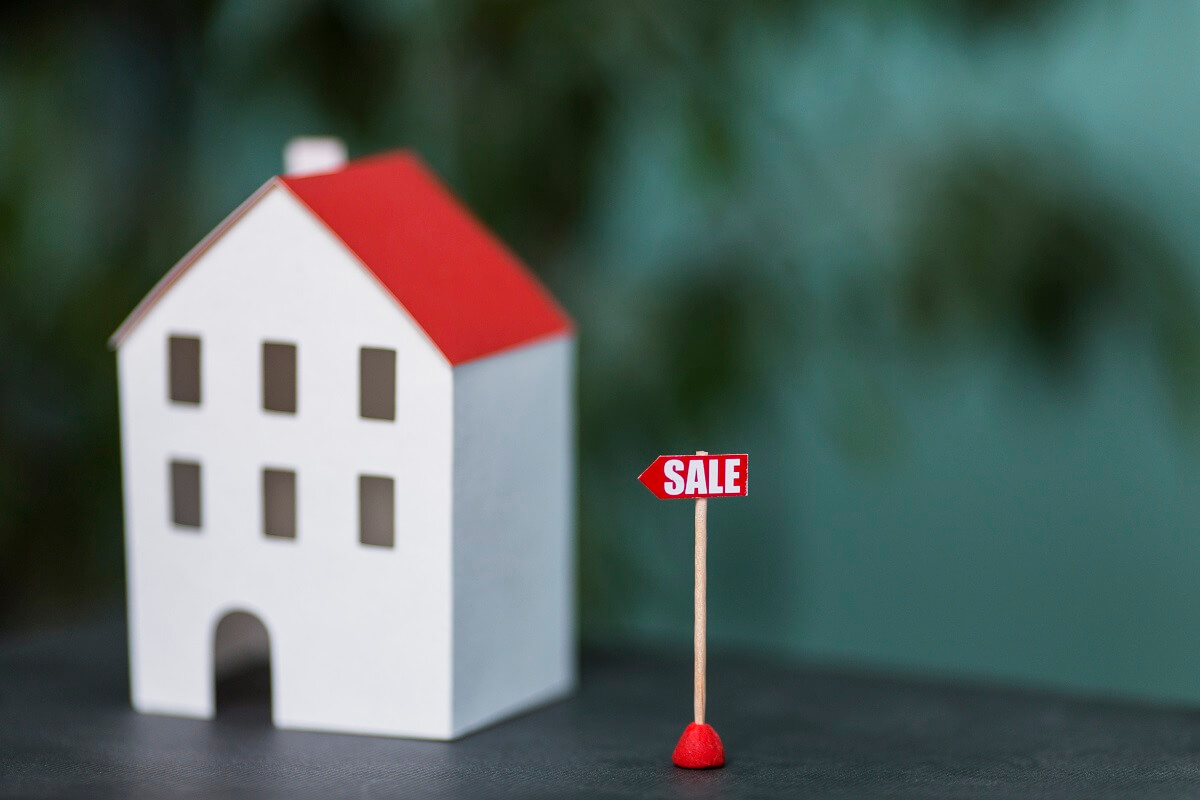 miniature-model-house-real-estate-sale-against-blurred-backdrop